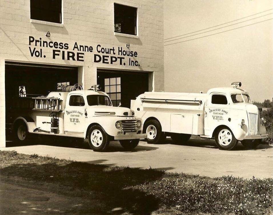 Two Princess Anne Courthouse fire trucks in front of the station circa 1949